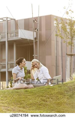 Young businesswomen arguing on office lawn View Large Photo Image Picture - Young businesswomen arguing on office lawn. Fotosearch