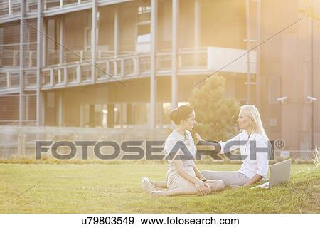 Young businesswomen discussing in office lawn View Large Photo Image Stock Photo - Young businesswomen discussing in office lawn. Fotosearch