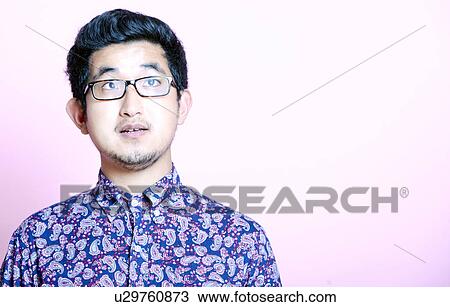 Young Geeky Asian Man in colorful shirt wearing glasses View Large Photo Image Stock Image - Young Geeky Asian Man in colorful shirt wearing glasses. Fotosearch