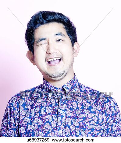 Stock Photo - Young Geeky Asian Man in colorful shirt . Fotosearch