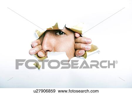 Young Korean man looking through ripped paper hole View Large Photo Image Stock Photo - Young Korean man looking through ripped paper hole. Fotosearch