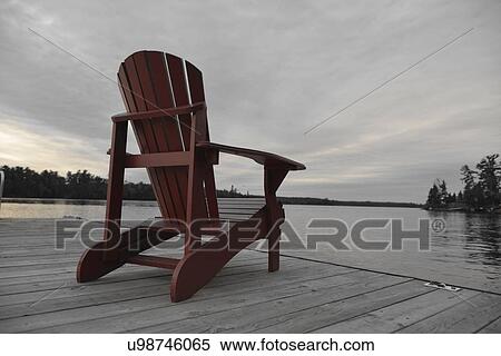 Adirondack chair on a deck at lake, Lake Of The Woods, Keewatin, Ontario, Canada View Large Photo Image Stock Photography - Adirondack chair on a deck at lake, Lake Of The Woods, Keewatin, Ontario, Canada. Fotosearch