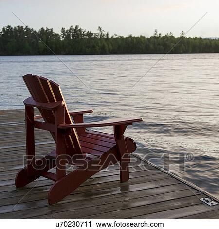 Adirondack chair on a dock at the Lake of The Woods, Ontario, Canada View Large Photo Image Stock Image - Adirondack chair on a dock at the Lake of The Woods, Ontario, Canada. Fotosearch