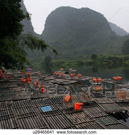 Stock Image - Bamboo rafts in the Yulong River, Yangshuo, Guilin, Guangxi Province, China. Fotosearch