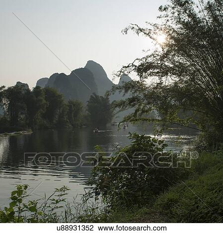 Bamboo rafts in the Yulong River, Yangshuo, Guilin, Guangxi Province, China View Large Photo Image Stock Image - Bamboo rafts in the Yulong River, Yangshuo, Guilin, Guangxi Province, China. Fotosearch