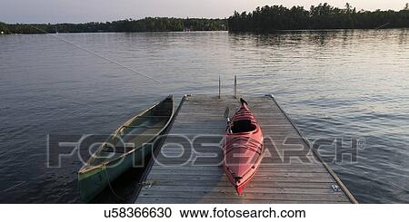 Stock Image - Boats at a dock, Lake Of The Woods, Keewatin, Ontario, Canada. Fotosearch