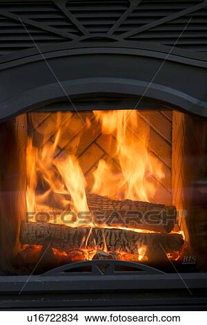 Burning wood in a fireplace, Lake of The Woods, Keewatin, Ontario, Canada View Large Photo Image Picture - Burning wood in a fireplace, Lake of The Woods, Keewatin, Ontario, Canada. Fotosearch
