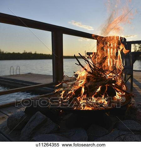 Stock Photography - Campfire on a dock, Lake of The Woods, Ontario, Canada. Fotosearch