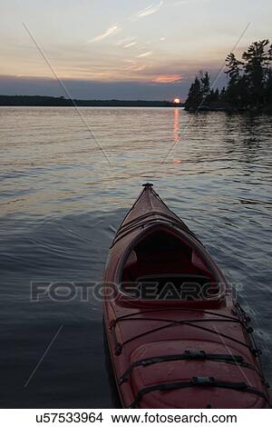 Picture - Canoe in a lake, Lake of The Woods, Keewatin, Ontario, Canada. Fotosearch