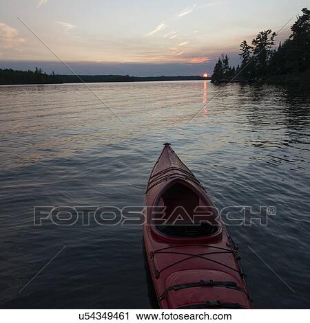 Stock Image - Canoe in a lake, Lake of The Woods, Keewatin, Ontario, Canada. Fotosearch