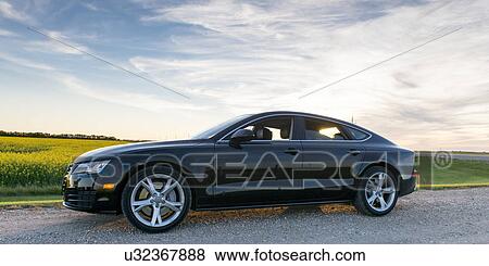 Stock Photo - Car on a country road, Manitoba, Canada. Fotosearch