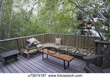 Chairs and a bench on a deck, Lake of The Woods, Keewatin, Ontario, Canada View Large Photo Image Stock Photo - Chairs and a bench on a deck, Lake of The Woods, Keewatin, Ontario, Canada. Fotosearch