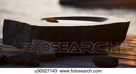 Stock Image - Close-up of a birdbath at a dock, Lake Of The Woods, Keewatin, Ontario, Canada. Fotosearch