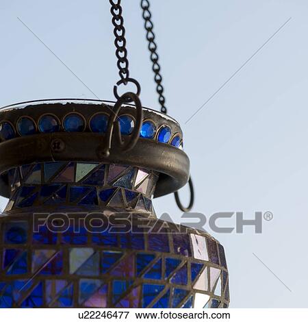Close-up of a decorative lantern hanging from a metal chain, Lake of The Woods, Ontario, Canada View Large Photo Image Stock Photo - Close-up of a decorative lantern hanging from a metal chain, Lake of The Woods, Ontario, Canada. Fotosearch