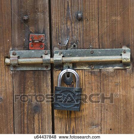 Close-up of a door locked with a padlock, Xingping, Yangshuo, Guilin, Guangxi Province, China View Large Photo Image Stock Photo - Close-up of a door locked with a padlock, Xingping, Yangshuo, Guilin, Guangxi Province, China. Fotosearch