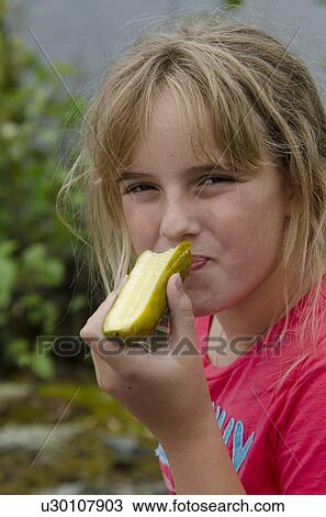 Close-up of a girl eating cucumber, Lake of The Woods, Keewatin, Ontario, Canada View Large Photo Image Stock Image - Close-up of a girl eating cucumber, Lake of The Woods, Keewatin, Ontario, Canada. Fotosearch