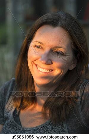 Stock Photograph - Close-up of a woman smiling, Lake of The Woods, Keewatin, Ontario, Canada. Fotosearch