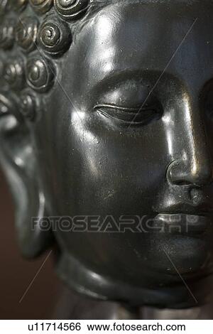 Stock Photograph - Close-up of Buddha statue, Lake of The Woods, Keewatin, Ontario, Canada. Fotosearch