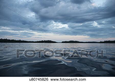 Clouds over the lake at dusk, Lake of The Woods, Keewatin, Ontario, Canada View Large Photo Image Stock Photograph - Clouds over the lake at dusk, Lake of The Woods, Keewatin, Ontario, Canada. Fotosearch