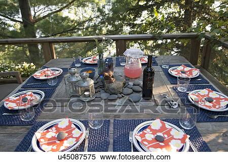 Stock Photography - Dining table on a deck at Lake of The Woods, Keewatin, Ontario, Canada. Fotosearch