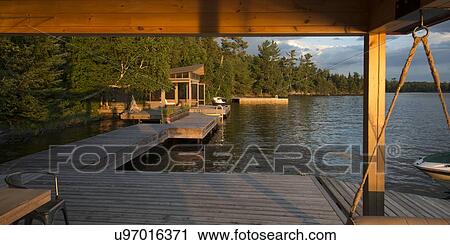 Stock Image - Dock at a lake, Lake Of The Woods, Keewatin, Ontario, Canada. Fotosearch
