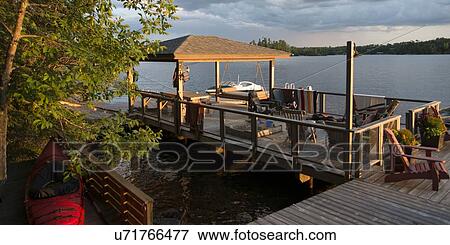 Stock Photo - Dock at a lake, Lake Of The Woods, Keewatin, Ontario, Canada. Fotosearch