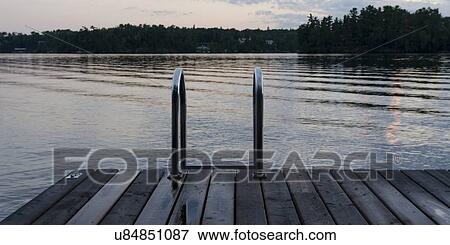 Stock Photo - Dock at a lake, Lake Of The Woods, Keewatin, Ontario, Canada. Fotosearch