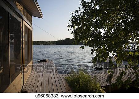 Stock Image - Dock at the lakeside, Lake of The Woods, Keewatin, Ontario, Canada. Fotosearch