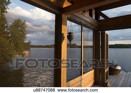 Stock Photo - Dock at the lakeside, Lake of The Woods, Keewatin, Ontario, Canada. Fotosearch