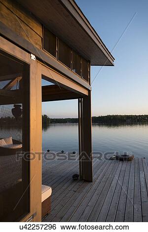 Stock Photograph - Dock at the lakeside, Lake of The Woods, Keewatin, Ontario, Canada. Fotosearch