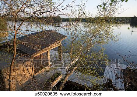 Stock Photography - Dock at the lakeside, Lake of The Woods, Keewatin, Ontario, Canada. Fotosearch