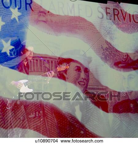 Picture - Double exposure of guitarist performing over the American Flag at Dutton Family Theater, Branson, Taney County, Missouri, USA. Fotosearch