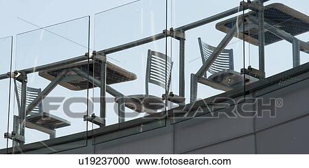 Stock Image - Empty tables and chairs on the terrace of a cafe, Universal Studios, Orlando, Florida, USA. Fotosearch