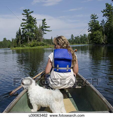 Girl boating in a lake, Lake of The Woods, Keewatin, Ontario, Canada View Large Photo Image Stock Image - Girl boating in a lake, Lake of The Woods, Keewatin, Ontario, Canada. Fotosearch