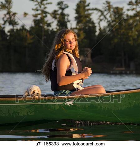 Girl boating in a lake, Lake of The Woods, Keewatin, Ontario, Canada View Large Photo Image Stock Image - Girl boating in a lake, Lake of The Woods, Keewatin, Ontario, Canada. Fotosearch