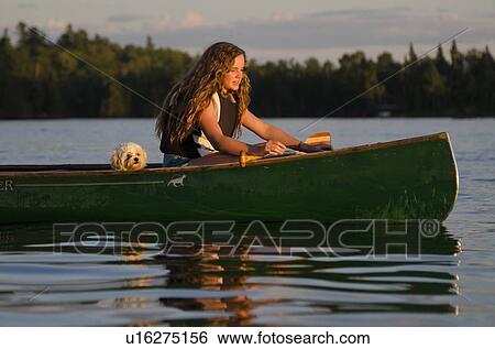 Girl boating in a lake, Lake of The Woods, Keewatin, Ontario, Canada View Large Photo Image Stock Photograph - Girl boating in a lake, Lake of The Woods, Keewatin, Ontario, Canada. Fotosearch