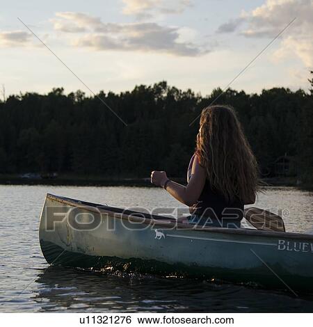 Girl rowing a boat in a lake, Lake of The Woods, Keewatin, Ontario, Canada View Large Photo Image Stock Photograph - Girl rowing a boat in a lake, Lake of The Woods, Keewatin, Ontario, Canada. Fotosearch