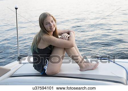 Girl sitting on a boat and smiling, Lake of The Woods, Keewatin, Ontario, Canada View Large Photo Image Stock Image - Girl sitting on a boat and smiling, Lake of The Woods, Keewatin, Ontario, Canada. Fotosearch