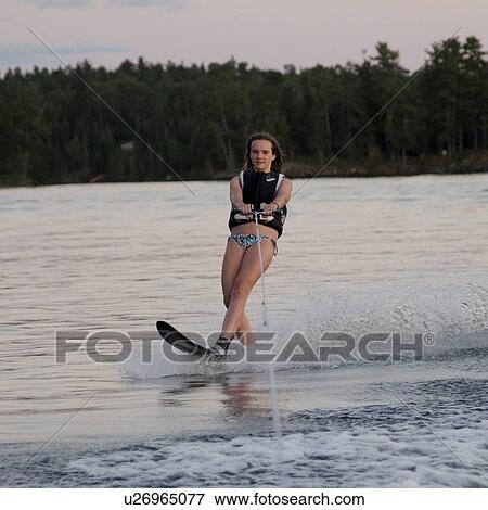 Stock Photo - Girl waterskiing in a lake, Lake of The Woods, Keewatin, Ontario, Canada. Fotosearch