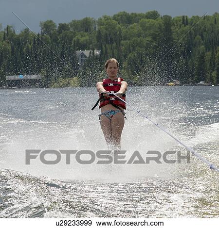 Stock Photo - Girl waterskiing in a lake, Lake of The Woods, Keewatin, Ontario, Canada. Fotosearch