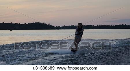 Stock Photo - Girl waterskiing in a lake, Lake of The Woods, Keewatin, Ontario, Canada. Fotosearch