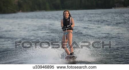 Girl waterskiing in a lake, Lake of The Woods, Keewatin, Ontario, Canada View Large Photo Image Stock Photography - Girl waterskiing in a lake, Lake of The Woods, Keewatin, Ontario, Canada. Fotosearch