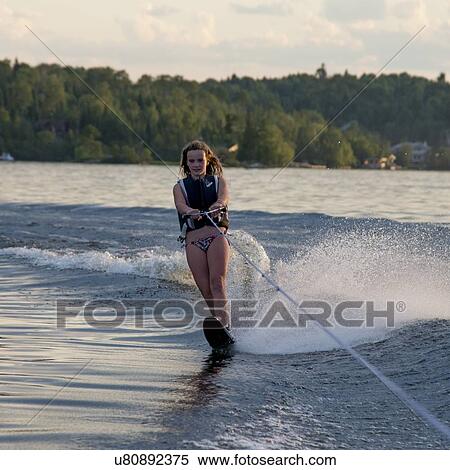 Stock Photography - Girl waterskiing in a lake, Lake of The Woods, Keewatin, Ontario, Canada. Fotosearch