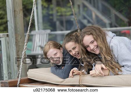 Girls lying on a swing and smiling, Lake of The Woods, Keewatin, Ontario, Canada View Large Photo Image Stock Photo - Girls lying on a swing and smiling, Lake of The Woods, Keewatin, Ontario, Canada. Fotosearch