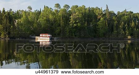 Stock Photo - Houseboat at lakeside, Lake Of The Woods, Keewatin, Ontario, Canada. Fotosearch