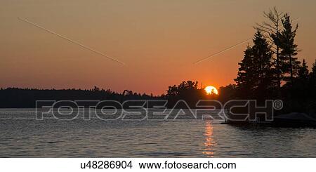 Picture - Lake at sunset, Lake Of The Woods, Keewatin, Ontario, Canada. Fotosearch