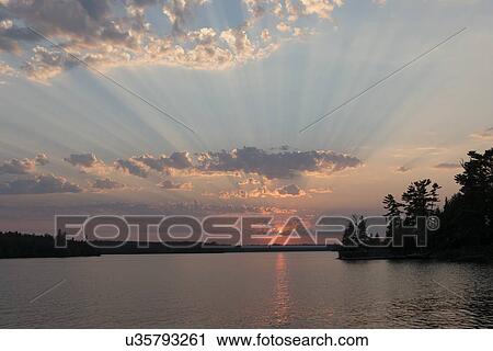 Stock Image - Lake at sunset, Lake Of The Woods, Keewatin, Ontario, Canada. Fotosearch