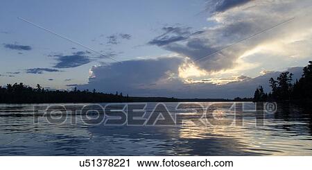 Stock Image - Lake at sunset, Lake Of The Woods, Keewatin, Ontario, Canada. Fotosearch