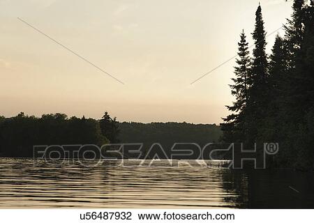Stock Image - Lake at sunset, Lake of The Woods, Keewatin, Ontario, Canada. Fotosearch