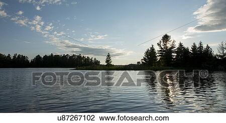 Stock Image - Lake at sunset, Lake Of The Woods, Keewatin, Ontario, Canada. Fotosearch